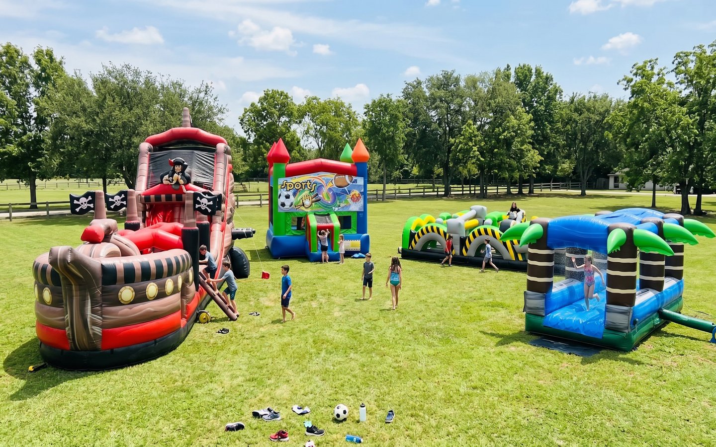 Moonwalk and bounce house rentals in Hutto TX - multiple inflatables set up at a party in Williamson County