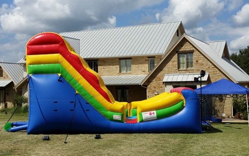 Colorful inflatable water slide rental Hutto TX backyard